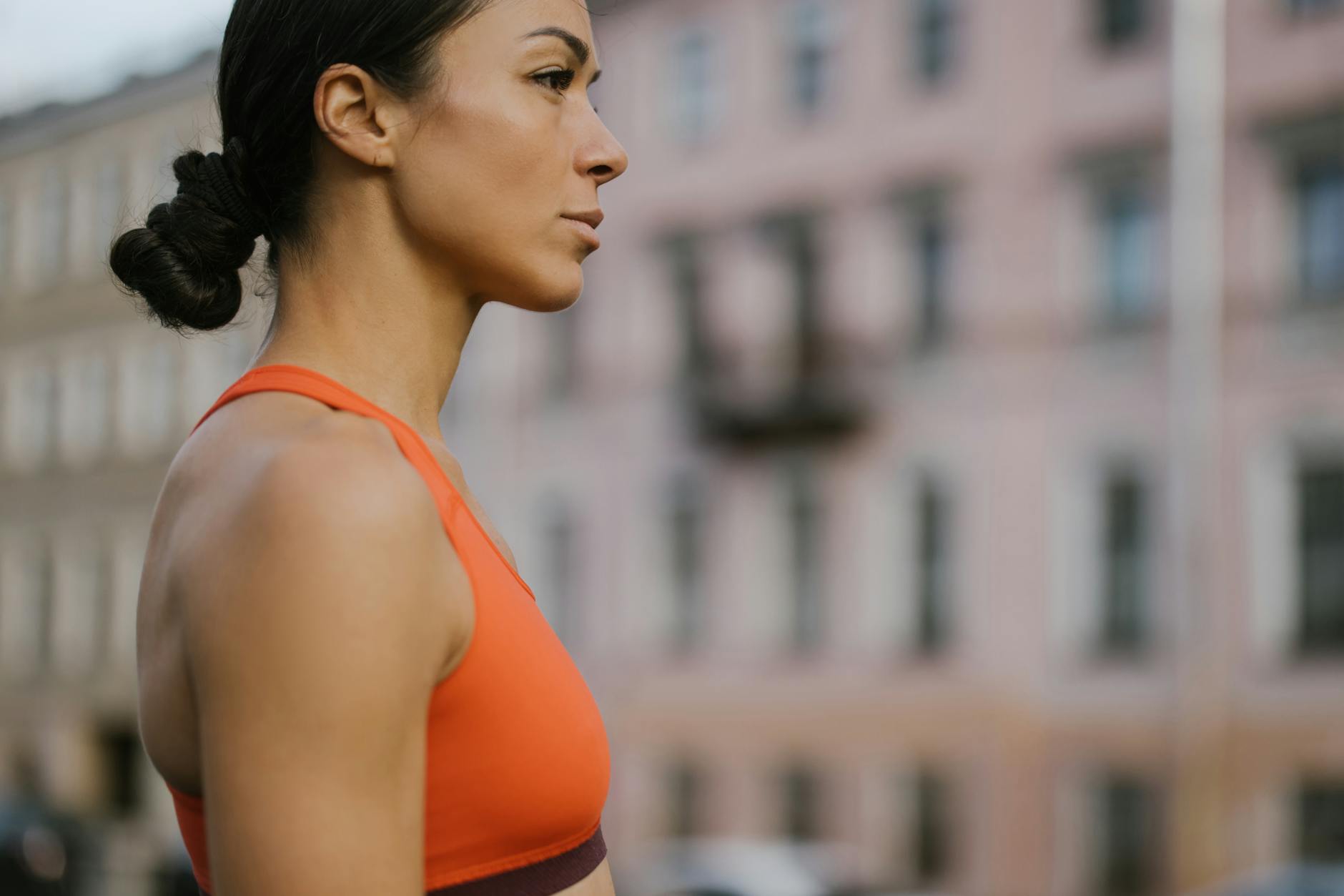A determined young woman jogging in a lush outdoor setting, conveying motivation for fitness and weight loss goals.