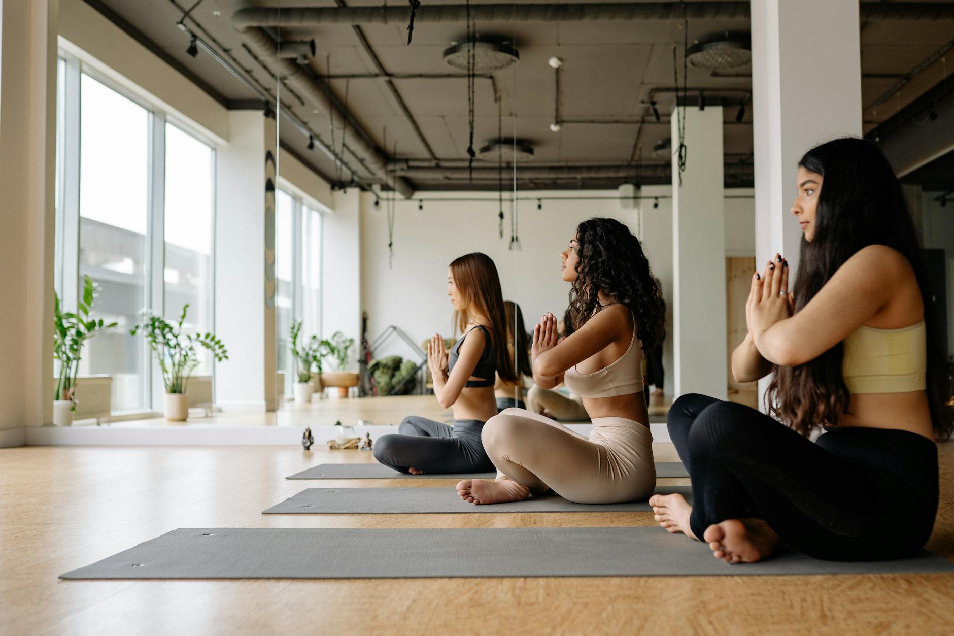 A woman in a serene pose, practicing meditation or yoga amidst lush greenery and vibrant flowers, promoting relaxation and wellness.